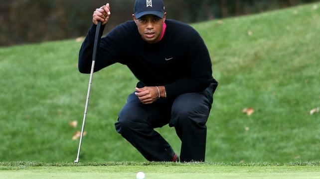 Tiger Woods lines up a putt at the World Challenge invitational