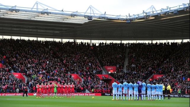 Teams and fans observe a minute of applause in memory of Nelson Mandela before kick-off