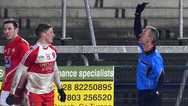 Referee Brendan Rice issues the first black card to Declan Mullan
