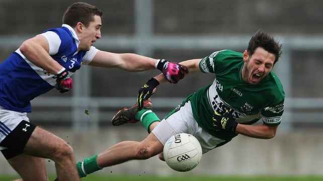 Portlaoise's Craig Rogers (r) is tackled by St Vincent's Jarlath Curley