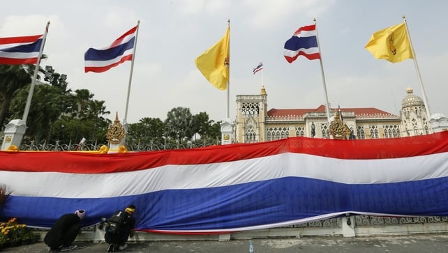 Thai protesters have wrapped Bangkok's Government House with a massive national flag Thai protesters have wrapped Bangkok's Government House with a massive national flag