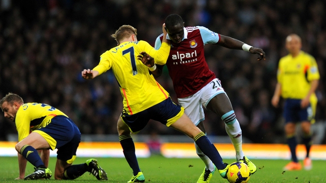 Mohamed Diame of West Ham is tackled by Sunderland's Sebastian Larsson