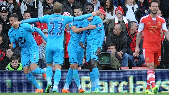 Goal scorer Emmanuel Adebayor is congratulated by his Spurs team-mates