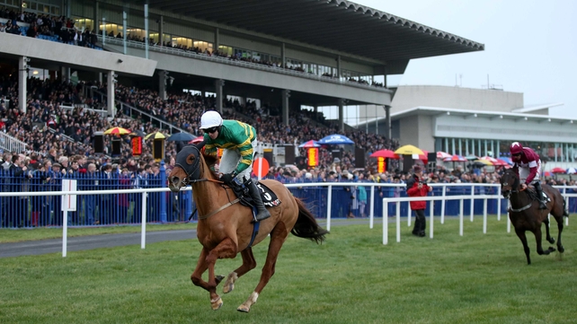 Mark Walsh onboard Defy Logic comes home to win the Racing Post Novice Chase