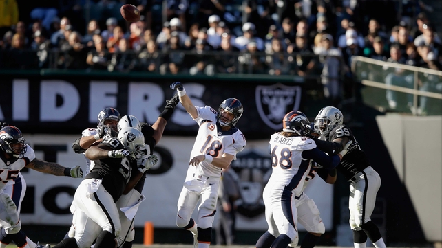 Denver Broncos quarterback Peyton Manning throws his third touchdown pass of the game against the Oakland Raiders
