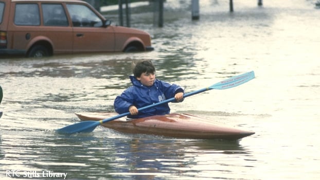 Boy canoes through the floods in Ballsbridge, Dublin in 1986. But who is he?