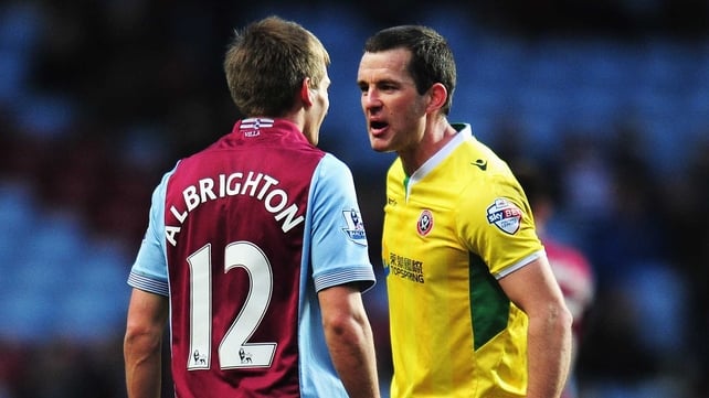 Michael Doyle of Sheffield United confronts Marc Albrighton