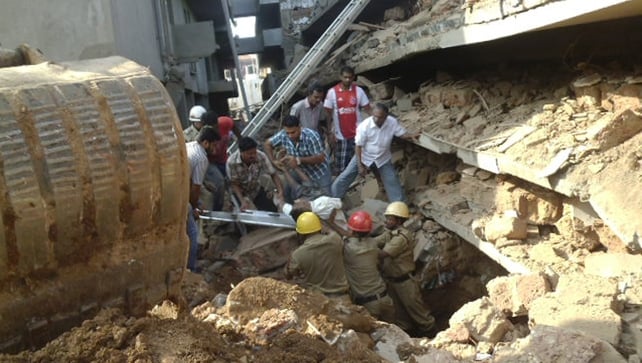 Rescue workers pull a victim from the rubble of a collapsed building in Goa Rescue workers pull a victim from the rubble of a collapsed building in Goa