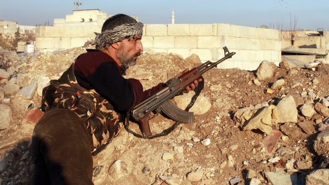 An opposition fighter guards a position in the northern Syrian city of Aleppo An opposition fighter guards a position in the northern Syrian city of Aleppo