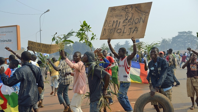 Demonstrators holding a placard reading 'Djotodia Resign' march to Mpoko airport Demonstrators holding a placard reading 'Djotodia Resign' march to Mpoko airport