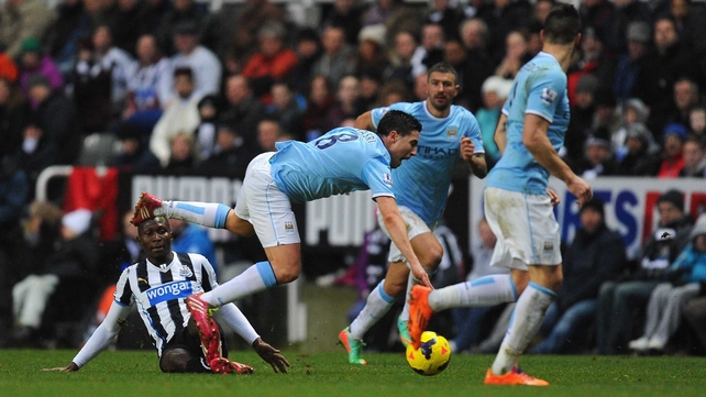 Samir Nasri goes down under the challenge from Mapou Yanga-Mbiwa