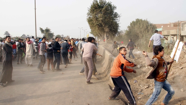 Egyptian Muslim Brotherhood supporters throw stones at voters outside a polling station Egyptian Muslim Brotherhood supporters throw stones at voters outside a polling station