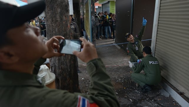 The Thai bomb squad unit examine the site of a blast at Victory monument in Bangkok The Thai bomb squad unit examine the site of a blast at Victory monument in Bangkok