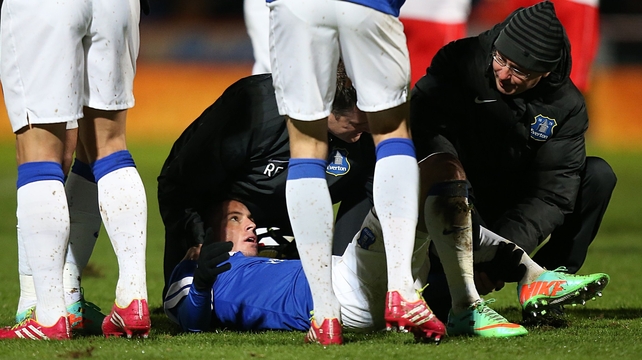 Everton's Bryan Oviedo lies injured after a tackle by Stevenage's Simon Heslop, resulting in a broken leg