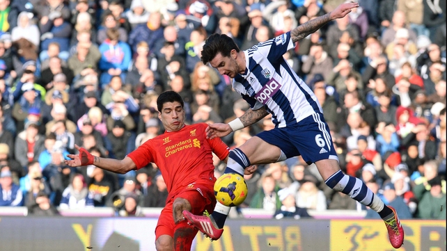 Liam Ridgwell gets there ahead of Luis Suarez