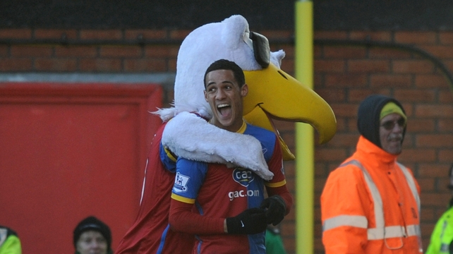 Palace's Tom Ince celebrates with the Eagles' mascot after scoring on his home debut