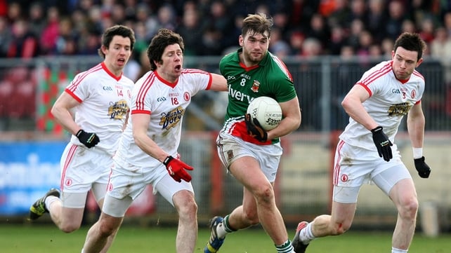 Seán Cavanagh in pursuit of Aidan O'Shea in Healy Park