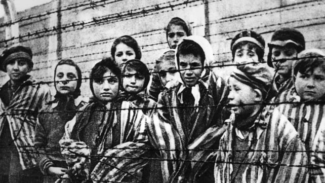 Children behind a barbed wire fence at the Nazi concentration camp at Auschwitz Children behind a barbed wire fence at the Nazi concentration camp at Auschwitz