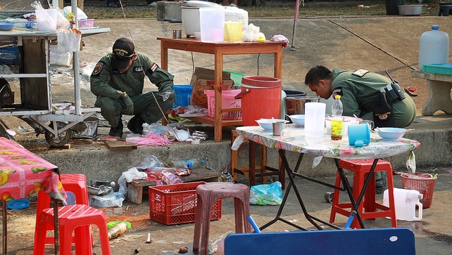 Members of a bomb squad unit inspect the site of an attack near an anti-government rally in Trat province Members of a bomb squad unit inspect the site of an attack near an anti-government rally in Trat province