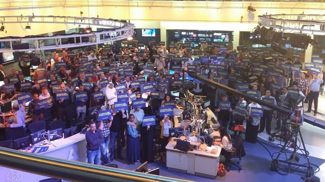 Dozens of staff of the Doha-based satellite news channel staged a five-minute gathering at the network's headquarters (@AJEnglish) Dozens of staff of the Doha-based satellite news channel staged a five-minute gathering at the network's headquarters (@AJEnglish)