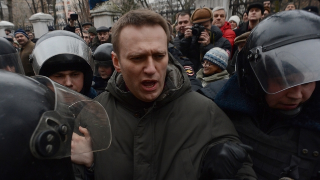 Police officers detain Alexei Navalny outside Zamoskvoretsky district court in Moscow on Monday Police officers detain Alexei Navalny outside Zamoskvoretsky district court in Moscow on Monday