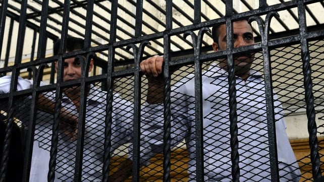 Two policemen Mahmoud Salah (L) and Awad Ismael (R) stand inside a court cage during their trial Two policemen Mahmoud Salah (L) and Awad Ismael (R) stand inside a court cage during their trial