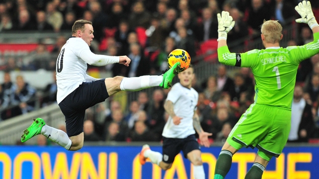 Wayne Rooney controls with Kasper Schmeichel looming