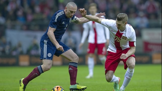 Scott Brown battles for posession with Lukasz Piszczek
