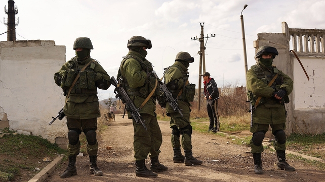 Pro-Russian forces stand guard outside a Ukrainian military base near the Crimean city of Simferopol Pro-Russian forces stand guard outside a Ukrainian military base near the Crimean city of Simferopol