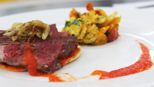 Seared ribeye of beef with red pepper tomatillo puree and sweetcorn tomato saute Seared ribeye of beef with red pepper tomatillo puree and sweetcorn tomato saute