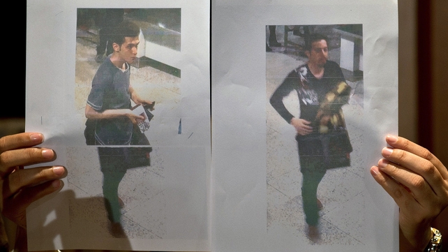 A Malaysian police official displays photographs of the two men who boarded flight MH370 using stolen European passports A Malaysian police official displays photographs of the two men who boarded flight MH370 using stolen European passports