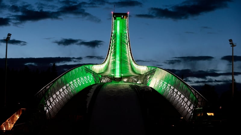 The landmark Holmenkollen ski jump is illuminated in green in Oslo, Norway (Pic: EPA)