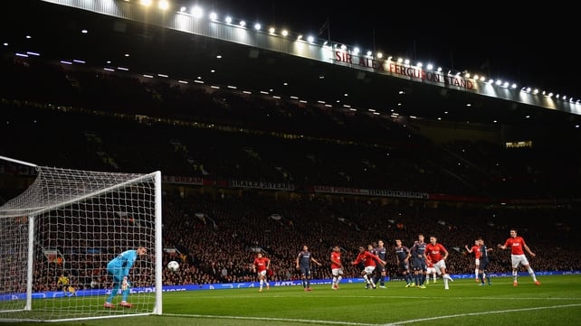 The Olympiakos goalkeeper Roberto watches on as Robin van Persie completes his hat-trick with a fine free kick