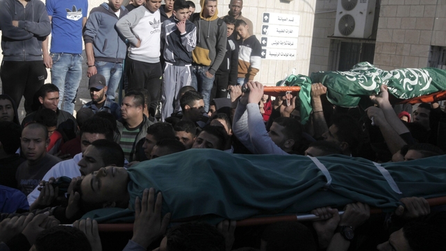 Palestinian men carry the bodies of comrades upon their arrival at an hospital in the Jenin refugee camp Palestinian men carry the bodies of comrades upon their arrival at an hospital in the Jenin refugee camp