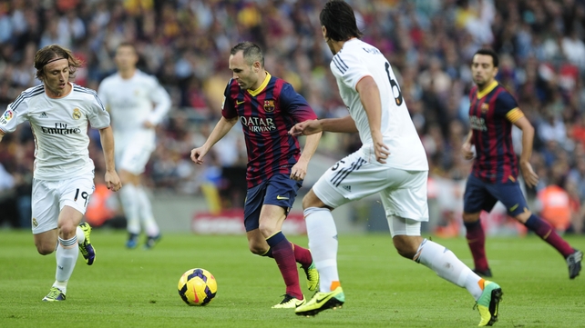 Andres Iniesta (C) vies with Real Madrid's Luka Modric (L) and Sami Khedira during last November's El Clasico