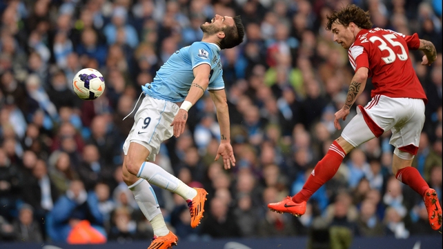 Alvaro Negredo winces in pain following a foul by Fulham's Fernando Amorebieta