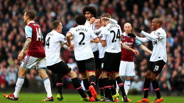 Wayne Rooney is mobbed following his wonder strike