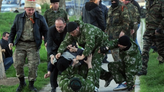 Pro-Russian militiamen beat an unidentified man as Russian soldiers stormed a Ukrainian military air base in the small city of Belbek near the Crimean city of Sevastopol Pro-Russian militiamen beat an unidentified man as Russian soldiers stormed a Ukrainian military air base in the small city of Belbek near the Crimean city of Sevastopol