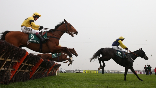 Paul Carberry and Guitar Peter jump the last in front en route to winning the Aintree opener