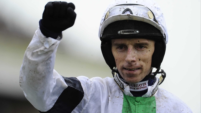 Leighton Aspell punches the air after guiding Pineau De Re to victory in the Aintree marathon