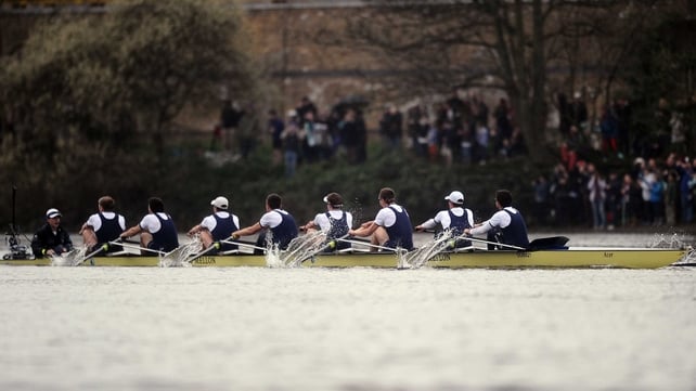 The victorious Oxford crew cross the finish line on the River Thames