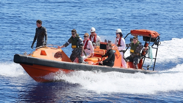 Navy personnel search the ocean for debris of the missing flight Navy personnel search the ocean for debris of the missing flight
