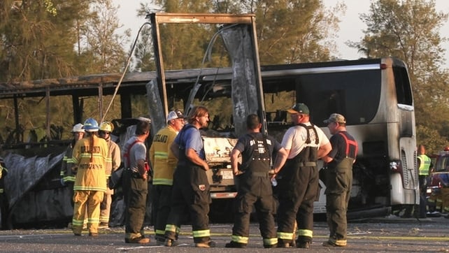 Pictures showed the bus reduced to a burned-out chassis resting sideways across the highway Pictures showed the bus reduced to a burned-out chassis resting sideways across the highway