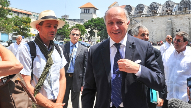 France's Foreign Minister Laurent Fabius (R) talks with tourists in Havana France's Foreign Minister Laurent Fabius (R) talks with tourists in Havana