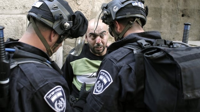 Israeli riot police check the ID as they arrest a Palestinian inside the Al Aqsa Mosque on Monday Israeli riot police check the ID as they arrest a Palestinian inside the Al Aqsa Mosque on Monday