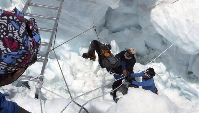 Mountain rescue workers lift an injured climber after the avalanche hit Mountain rescue workers lift an injured climber after the avalanche hit
