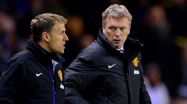 Manchester United coach Phil Neville (L) with manager David Moyes