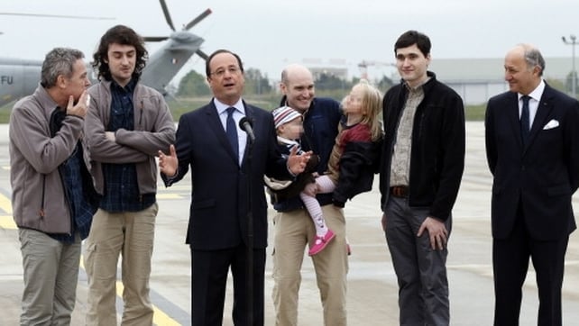 The journalists were greeted by French President Francois Hollande and their families The journalists were greeted by French President Francois Hollande and their families