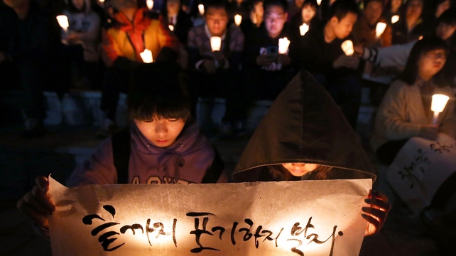 People hold candles as they pray for the safe return of passengers of the sunken ferry in Ansan, South Korea People hold candles as they pray for the safe return of passengers of the sunken ferry in Ansan, South Korea