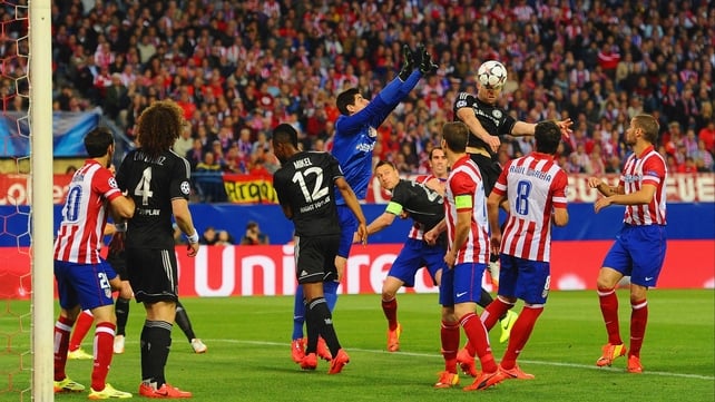 Gary Cahill gets to a cross ahead of Atletico 'keeper Thibaut Courtois